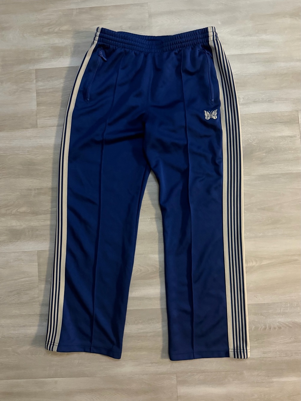 Needles Navy Blue Track Pants with Cream Embroidered Logo Side Stripes